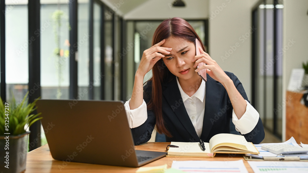 Young female employee having serious conversation on smartphone, arguing with client, solve business problem Young female employee having serious conversation on smartphone, arguing with client, solve business problem