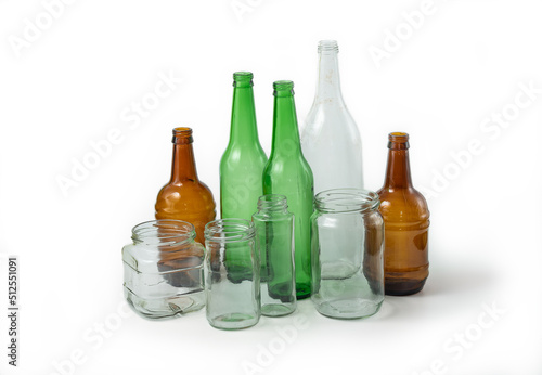 Glass ready to recycle, isolated on white background. A collection of different colored glass bottles and jars. Recycle concept.