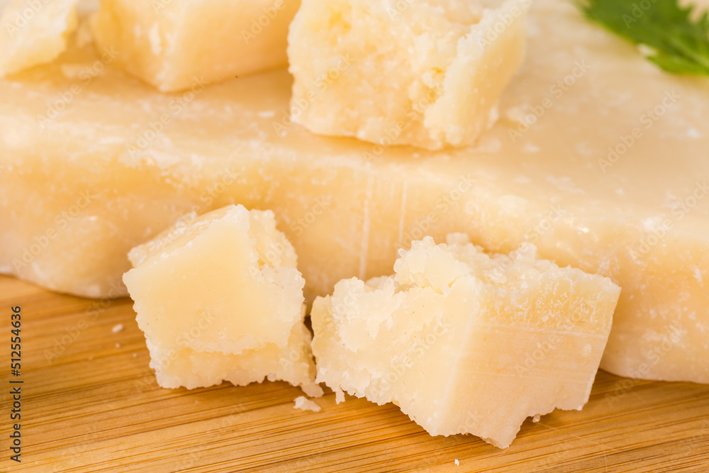 Hard cheese on wooden surface, close-up in selective focus Hard cheese on wooden surface, close-up in selective focus