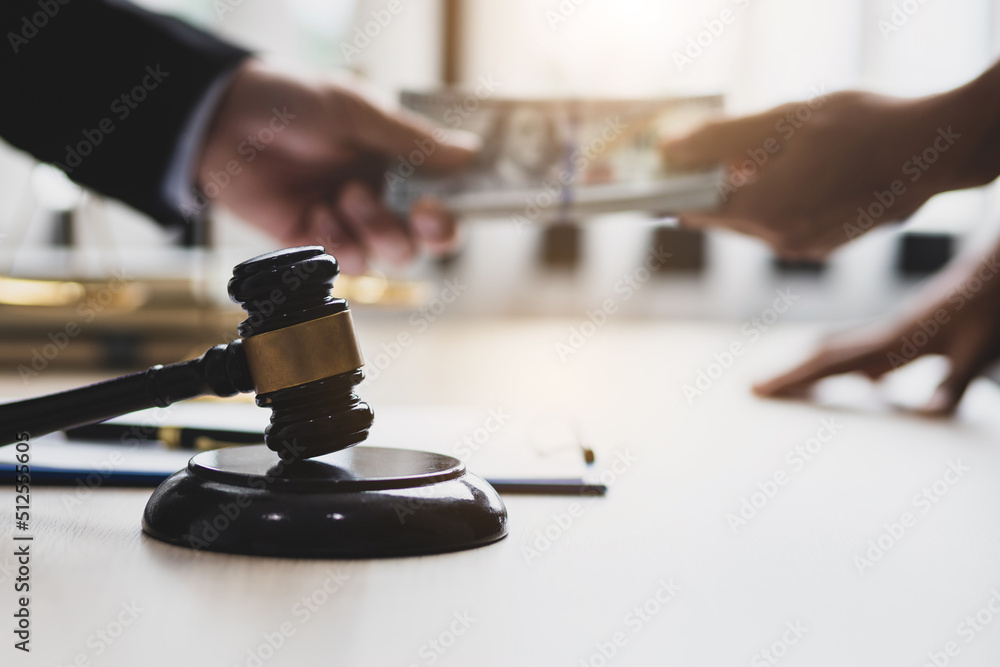 Business people shaking hands and bribe to an attorney to help a lawyer win a court case. The concept of bribing lawyers and paying lawsuits. Business people shaking hands and bribe to an attorney to help a lawyer win a court case. The concept of bribing lawyers and paying lawsuits.