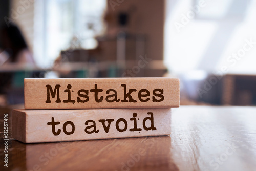 Photos Wooden blocks with words 'Mistakes To Avoid'.
