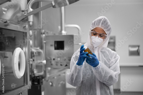 Female scientist holding medicine in a drug manufacturing laboratory