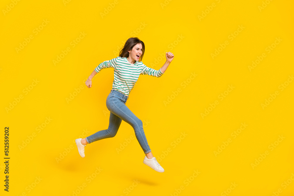 Full body profile side photo of charming good mood girl traveling running being sportive active isolated on yellow color background Full body profile side photo of charming good mood girl traveling running being sportive active isolated on yellow color background