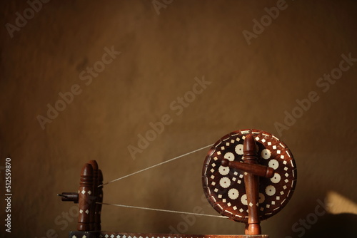 The Charkha supplemented the agriculture of the villagers and gave it dignity. mahatma gandhi. " selective focus" " shallow depth of field" or " blur"