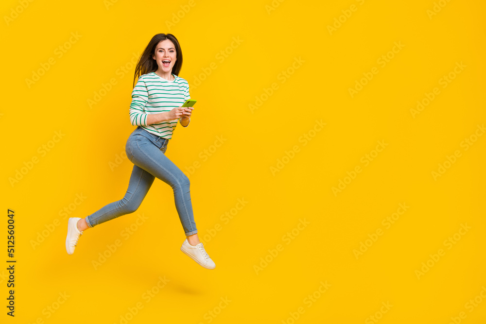 Full body image of cute cheerful girl chatting in phone receive many likes on her photo isolated on yellow color background