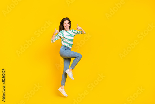 Full size photo of cheerful attractive charming girl show thumb-up promote product isolated on yellow color background