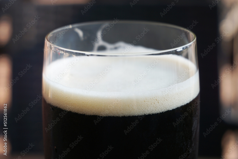 Glass of dark beer, defocused background Glass of dark beer, defocused background