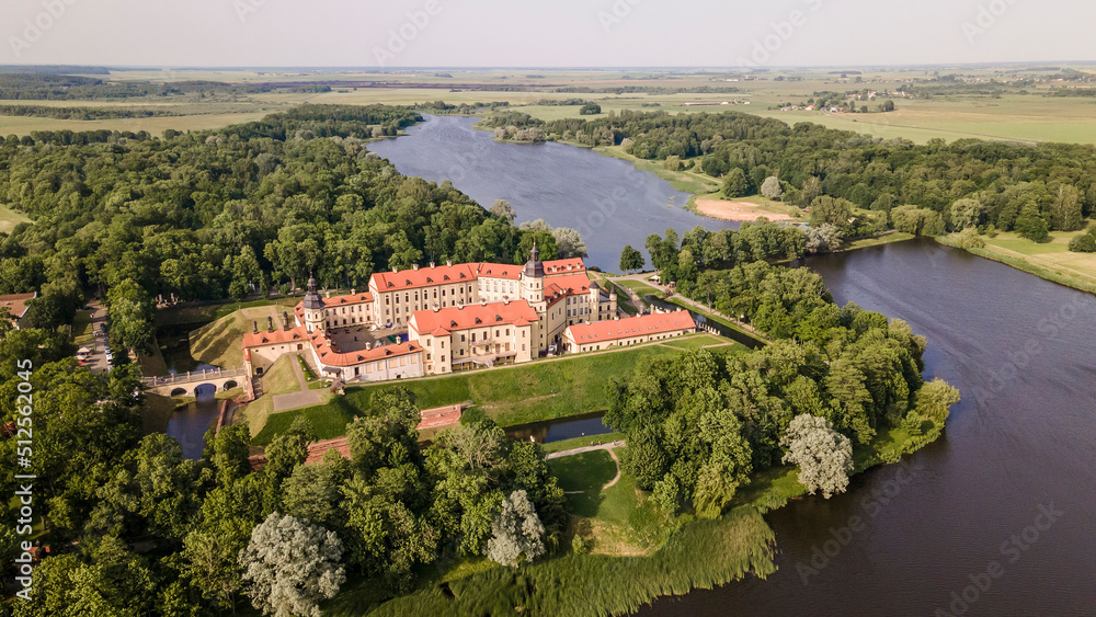 Aerial view of Nesvizh Castle and river, Belarus. Medieval castle and palace. Restored medieval fortress.