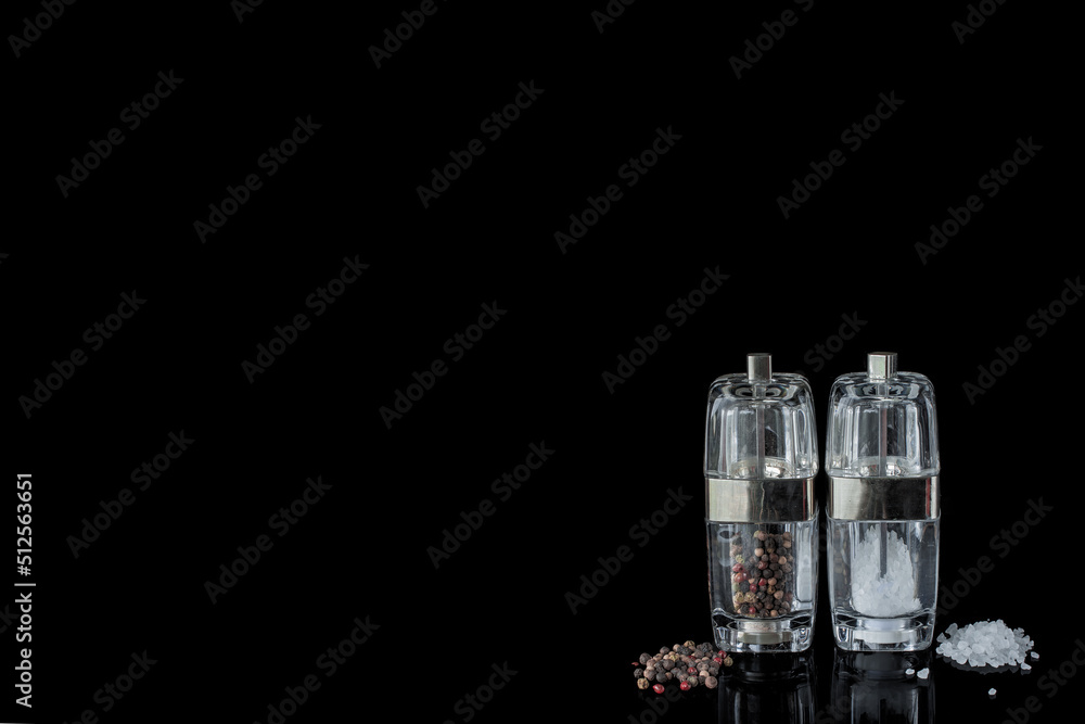 Salt and pepper shakers on reflecting background