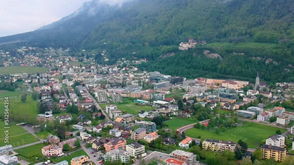 Picturesque View Of Vaduz Town Nestled In The Foothills Of Dense Mountains In Liechtenstein. Aerial Wide Shot Picturesque View Of Vaduz Town Nestled In The Foothills Of Dense Mountains In Liechtenstein. Aerial Wide Shot
