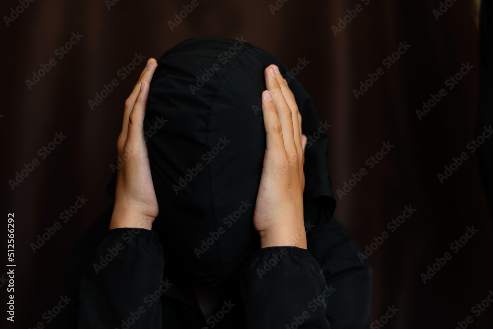 Portrait of blonde teenage boy on dark background outdoor. Low key close up shot of a young teen boy, adolescence. Selective focus. Loneliness, sadness, adolescent anxiety, emotional Portrait of blonde teenage boy on dark background outdoor. Low key close up shot of a young teen boy, adolescence. Selective focus. Loneliness, sadness, adolescent anxiety, emotional