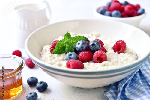 Oatmeal porridge with fresh berries for a breakfast.