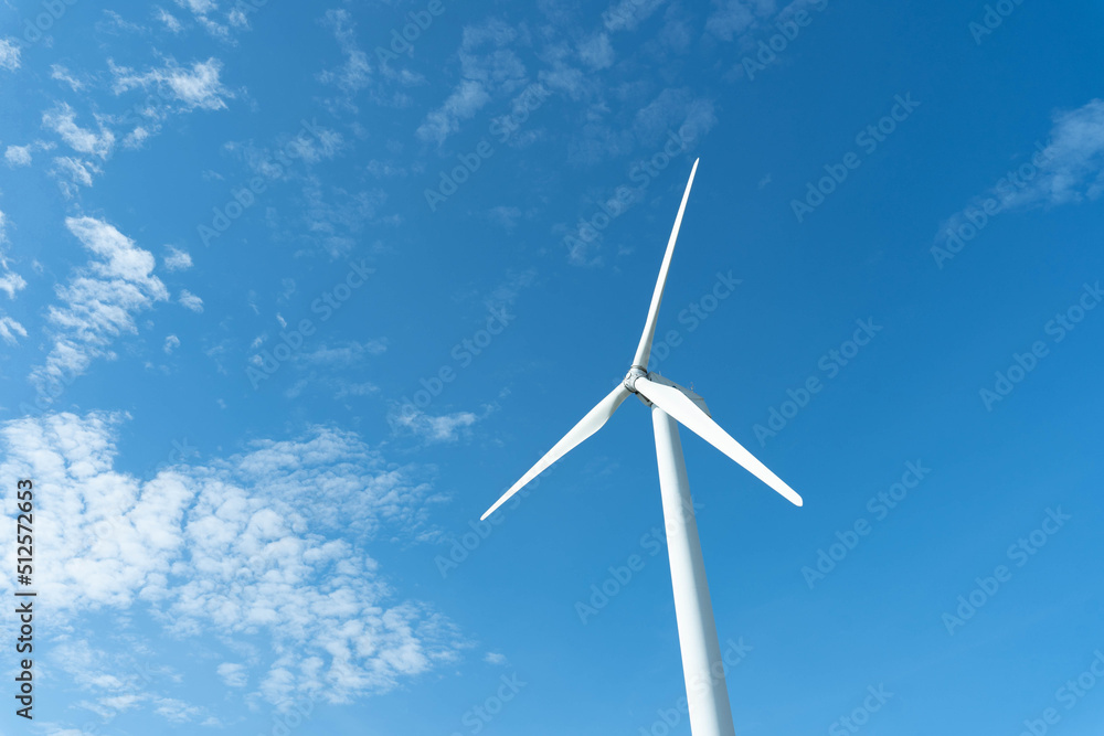 wind mill or also wind-turbine on wind farm in rotation to generate electricity energy on outdoor with sun and blue sky; conservation and sustainable energy concept. wind mill or also wind-turbine on wind farm in rotation to generate electricity energy on outdoor with sun and blue sky; conservation and sustainable energy concept.