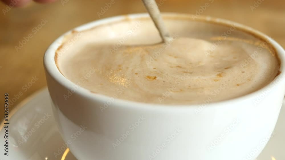 slow motion of stirring coffee with spoon. slow motion of stirring coffee with spoon.