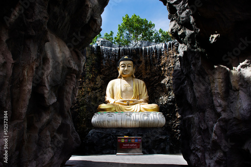 Beautiful buddha statue in garden for thai people travel visit respect praying in gardening fountain waterfalls of Wat Laksi Rat Samosorn temple at Ban Phaeo on June 8, 2022 in Samut Sakhon, Thailand photo