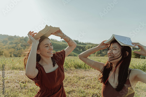 HAPPY GIRLS STUDYING TOGETHER IN THE COUNTRYSIDE.  photo