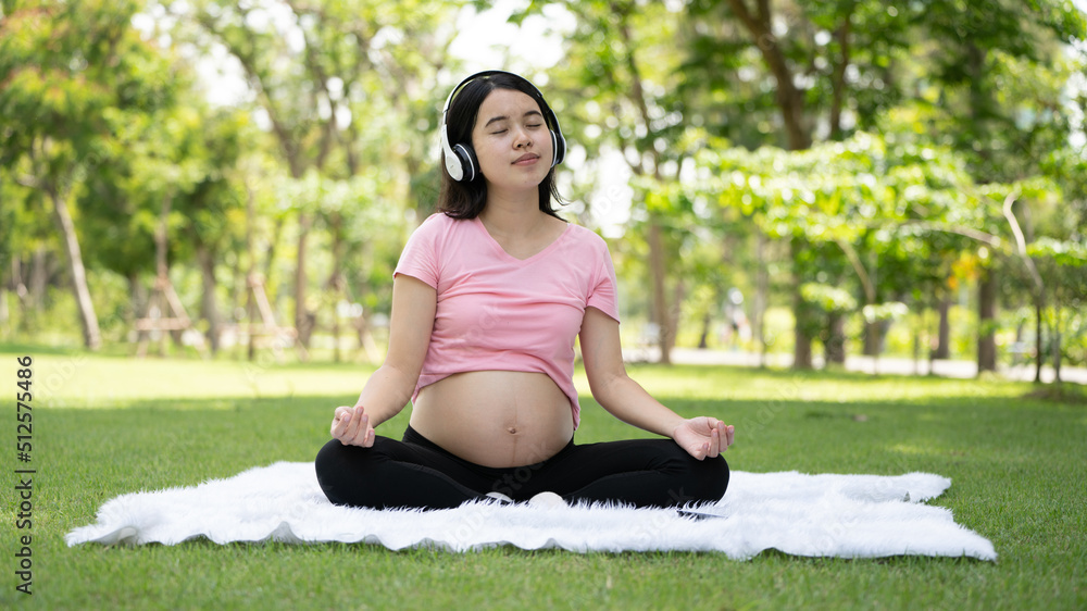 Pregnant woman touching belly in the City Park, Pregnant Relaxing and exercise, Beautiful tender mood photo of pregnancy Pregnant woman touching belly in the City Park, Pregnant Relaxing and exercise, Beautiful tender mood photo of pregnancy