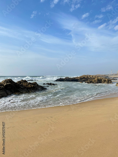 Stunning view of yellow sandy beach with rocks and Atlantic ocean in Matosinhos Beach in Portugal
