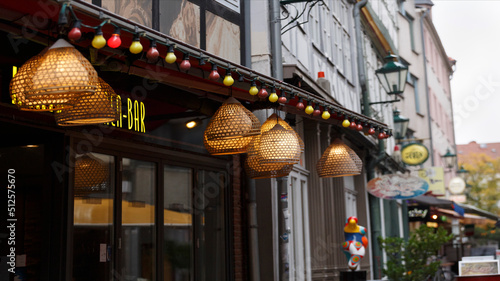 Fototapeta Naklejka Na Ścianę i Meble -  background of European city street with garlands, shop windows, cafe signboards