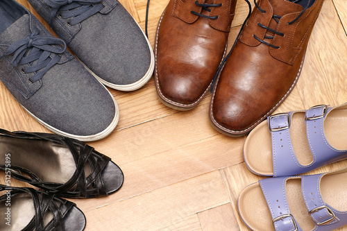 Women's and men's shoes on the parquet floor photo