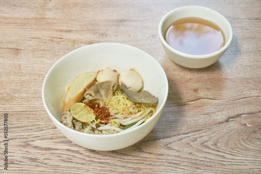 boiled dry Chenese yellow egg noodles with entrails and meatball on bowl boiled dry Chenese yellow egg noodles with entrails and meatball on bowl