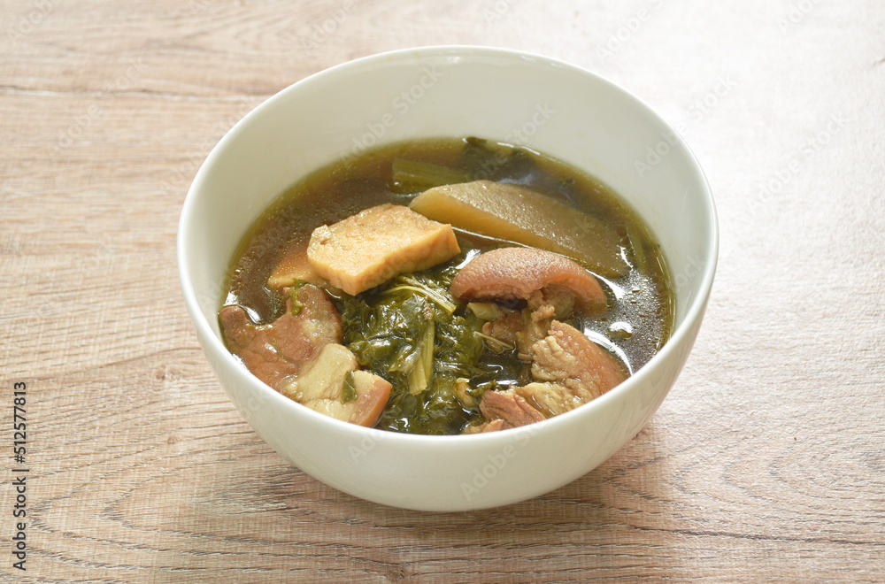boiled mixed vegetable with pork belly and tofu in black soybean soup in bowl boiled mixed vegetable with pork belly and tofu in black soybean soup in bowl