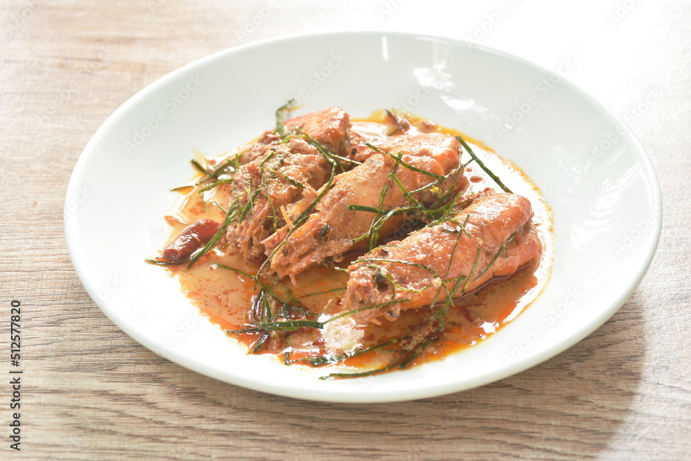 spicy stir fried river shrimp with slice grass leaf curry on plate spicy stir fried river shrimp with slice grass leaf curry on plate