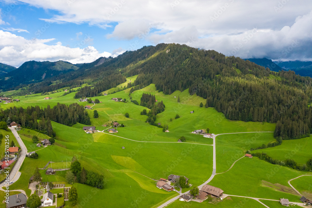 Aerial view of fields and landscape with mountains in the center of Switzerland in the Berner Oberland