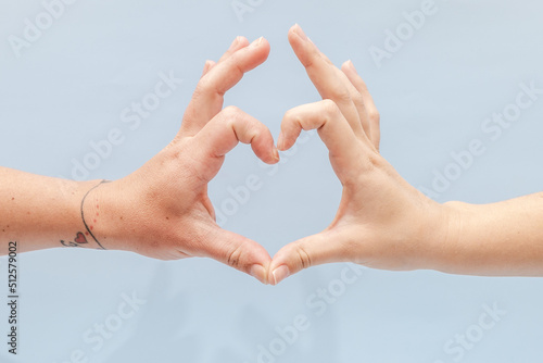 Two hands gesturing on a blue background