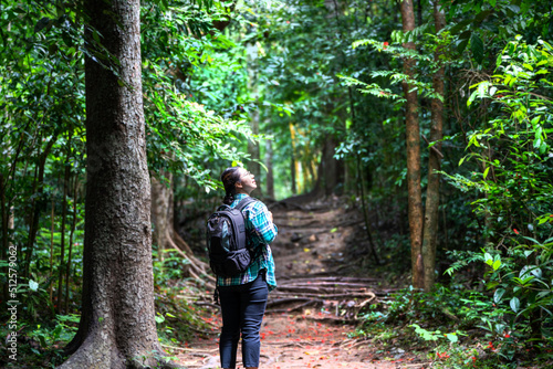 Woman with backpack exploring the beautiful rain forest on Sub madue Petchabun Thailand. Travel and ecotourism concept © Yellow Boat