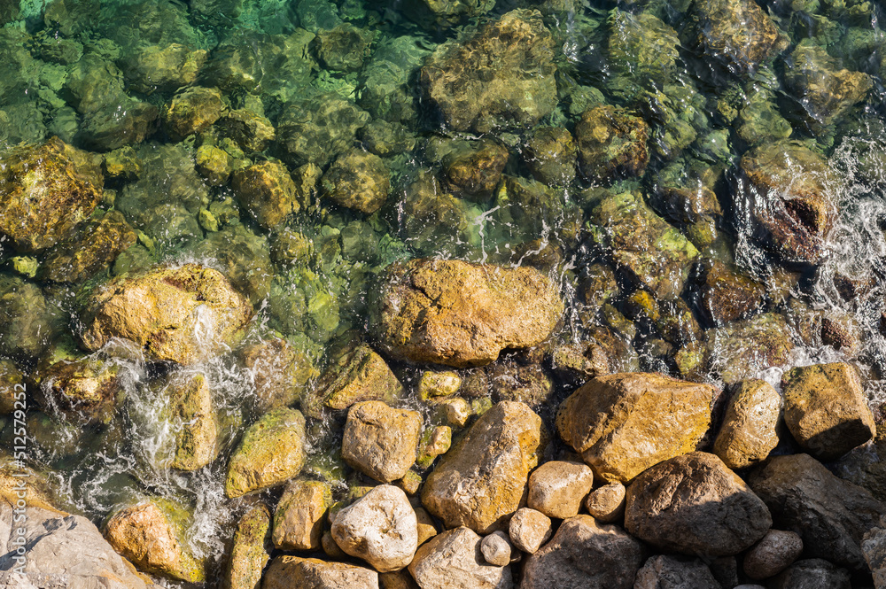 Sea surface, waves breaking on the rocks. Beautiful sea background, rocks