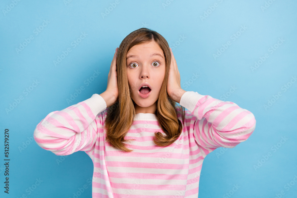 Portrait of shocked confused person hands head cover eyes open mouth isolated on blue color background Portrait of shocked confused person hands head cover eyes open mouth isolated on blue color background
