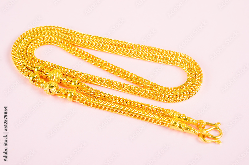 Gold necklace on pink background. Gold necklace on pink background.
