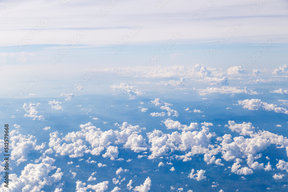 Fototapeta premium Aerial view of Fluffy clouds Top view from airplane window, Nature background.