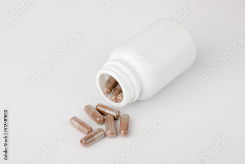 White bottle with filled capsule mockup on white background