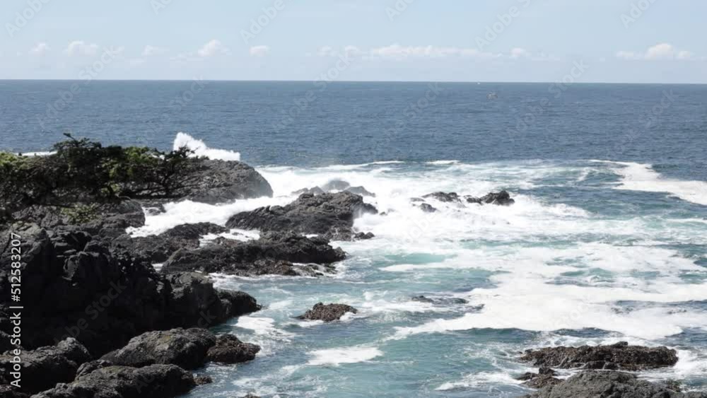 A slow motion handheld video of waves crashing against the rocks on the ocean coast. A slow motion handheld video of waves crashing against the rocks on the ocean coast.