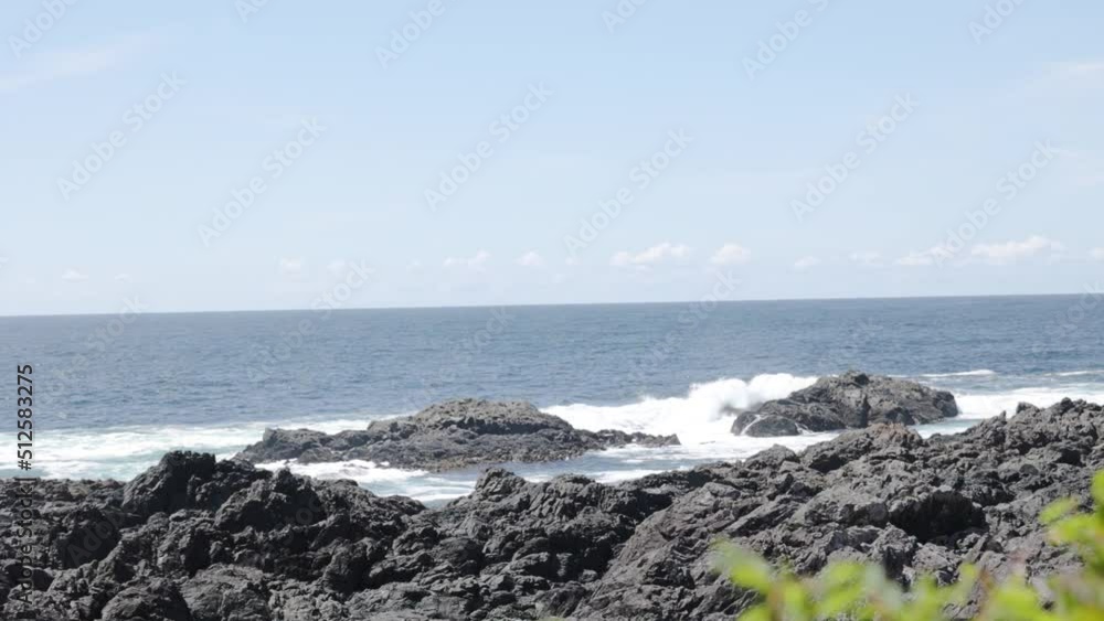A slow motion handheld video of waves crashing against the rocks on the ocean coast. A slow motion handheld video of waves crashing against the rocks on the ocean coast.