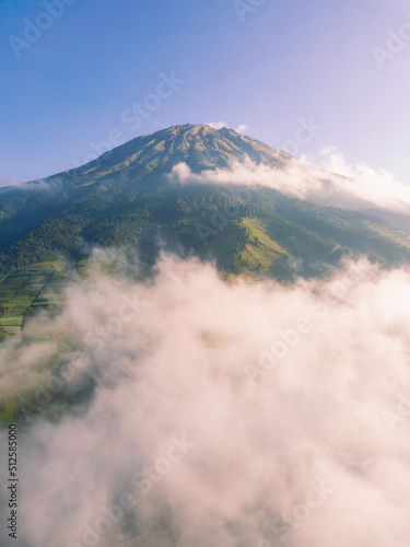 The peak of the Mount Sumbing with sea of clouds and blue sky. Central Java, Indonesia