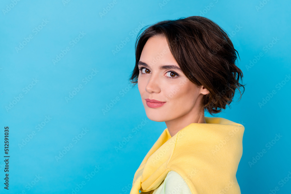 Photo of shiny adorable lady dressed yellow pullover smiling empty space isolated blue color background Photo of shiny adorable lady dressed yellow pullover smiling empty space isolated blue color background