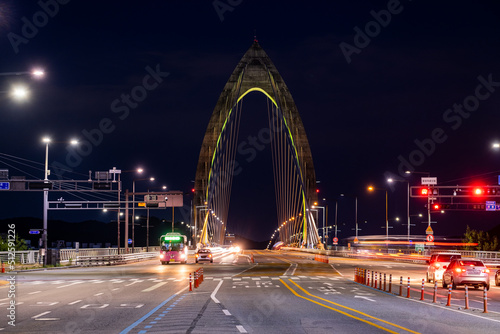 Scenic view of cars and light trails during sunset