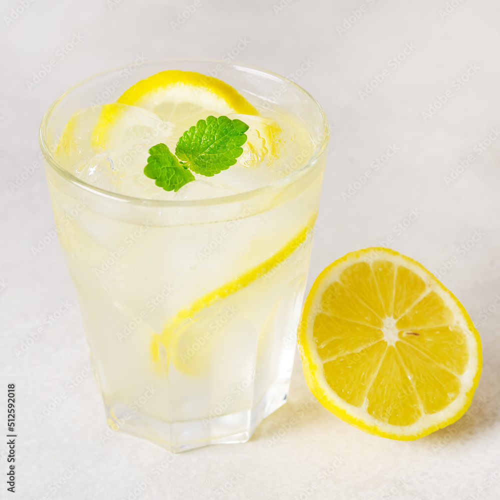 Lemonade Drink of Soda Water with Lemon and Fresh Mint in a Glass Tasty Healthy Summer Drink Gray Background Square Lemonade Drink of Soda Water with Lemon and Fresh Mint in a Glass Tasty Healthy Summer Drink Gray Background Square