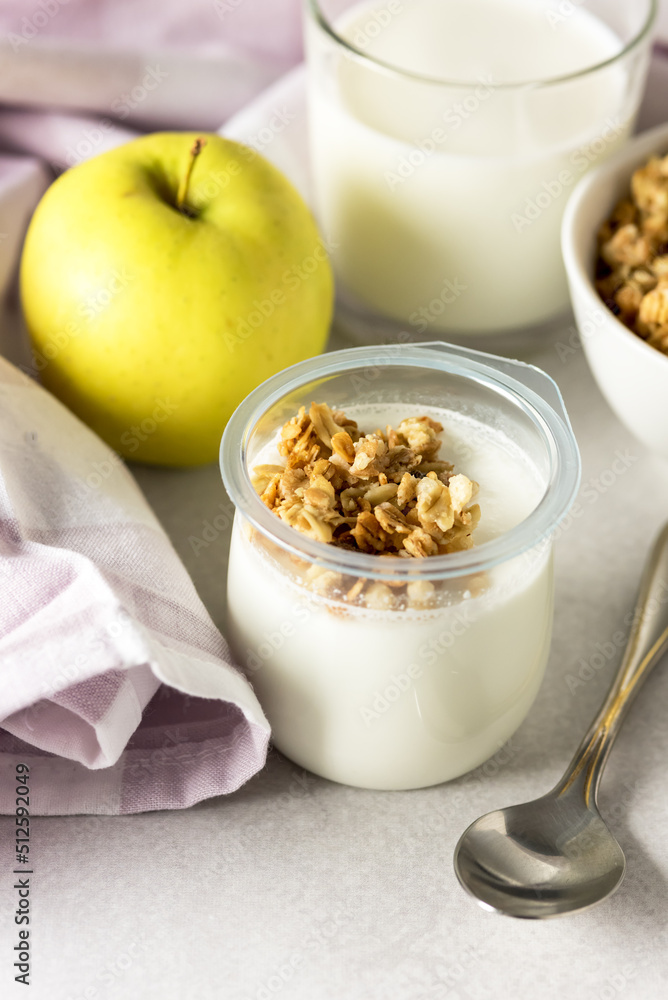 Portions of Fresh Natural Homemade Organic Yogurt Bowl of Granola Raw Apple Napkin Glass of Milk Breakfast Concept Vertical Portions of Fresh Natural Homemade Organic Yogurt Bowl of Granola Raw Apple Napkin Glass of Milk Breakfast Concept Vertical
