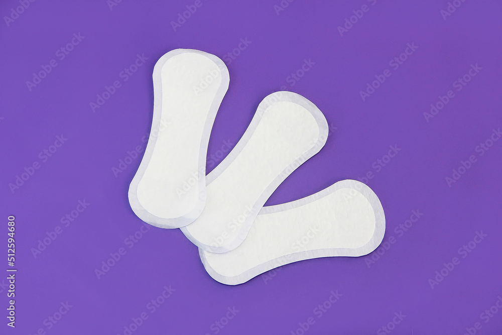 women's hygienic daily pads for secretions on a purple background very peri women's hygienic daily pads for secretions on a purple background very peri