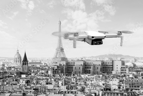 Drone with 4k digital camera flying over Paris city with Eiffel tower at the background in Paris, France. Technology background