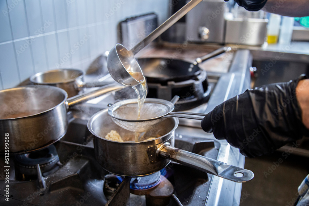 Chef Separating Water From Rice Using Strainer In Kitchen Chef Separating Water From Rice Using Strainer In Kitchen