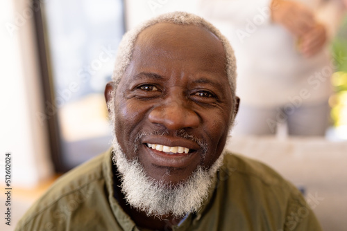 Close-up portrait of smiling bearded african american senior man in nursing home