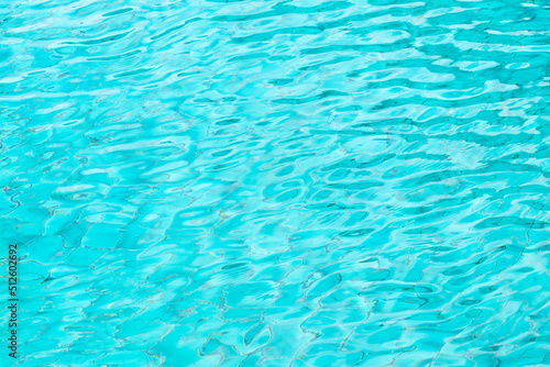 Ripple Water in swimming pool with blue tile floor background