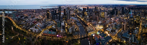 Panoramic aerial drone view of Melbourne City, Victoria, Australia looking in the direction of Port Phillip above Yarra River in the early morning 