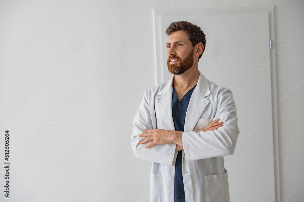 Portrait of handsome doctor in uniform standing in medicine clinic hall and looking away Portrait of handsome doctor in uniform standing in medicine clinic hall and looking away