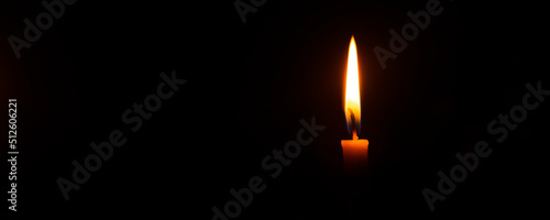 Candles and black background,Single lit candle with quite flame 